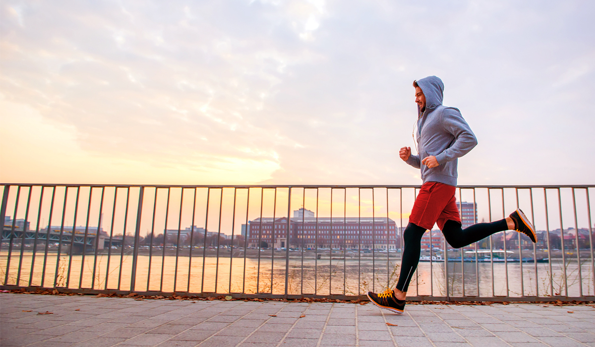 A handsome young man running in the sunset next to a fence on the riverside
; Shutterstock ID 704619925; job: Generali global