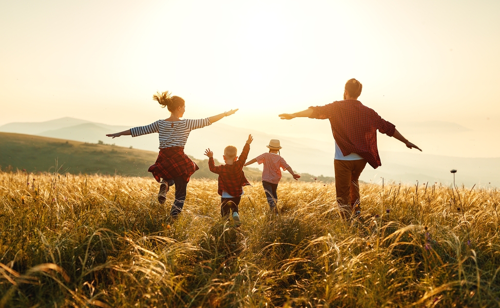 Happy family: mother, father, children son and  daughter on nature  on sunset